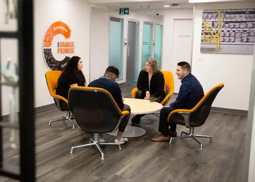 Home Depot Canada corporate team members having a meeting in a modern office space.