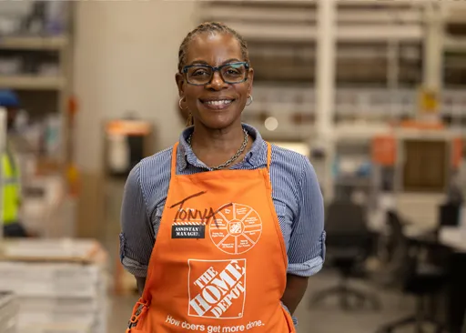 Home Depot assistant store manager smiling confidently in retail environment